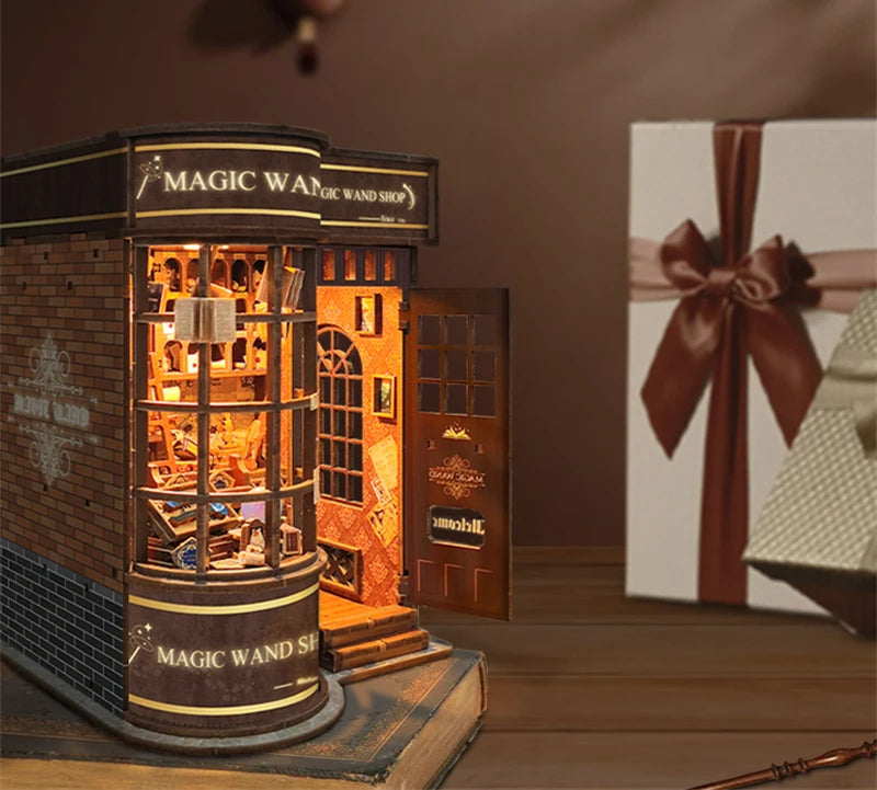 A wooden miniature kit of a magic wand shop display featuring an illuminated storefront and wooden elements.