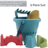 A 6 piece suit of beach castle sand play accessories including a bucket, scoop, and building blocks in pink, blue, and green.