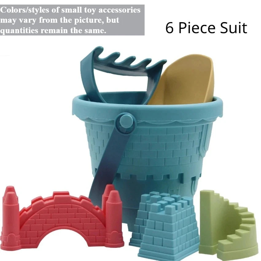 A 6 piece suit of beach castle sand play accessories including a bucket, scoop, and building blocks in pink, blue, and green.