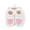 Pair of white knitted baby booties with pink and gray elephant designs