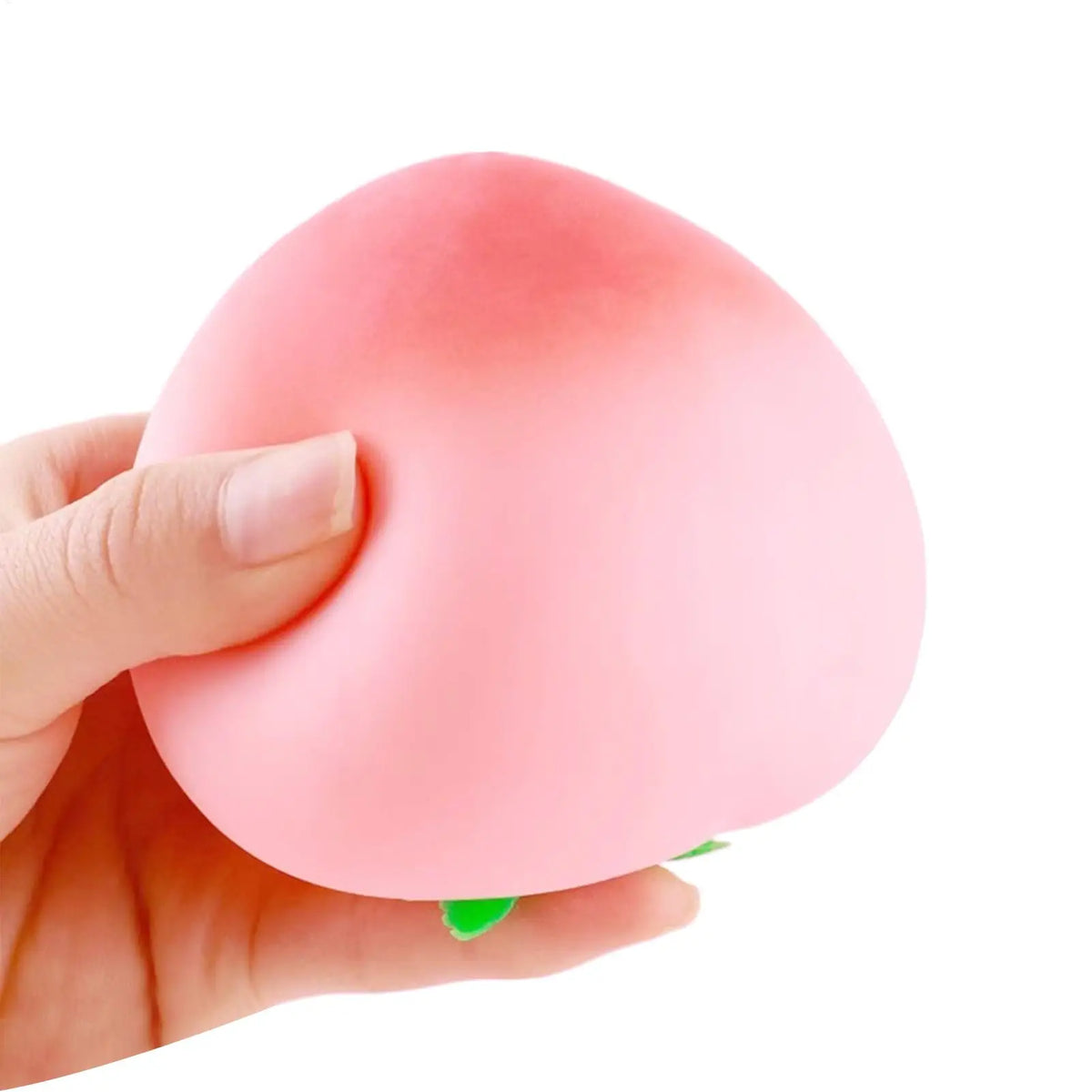 A hand is squeezing a pink, peach-shaped stress relief toy.