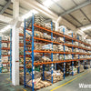 Warehouse interior showing large racks of natural blue cat eye stone beads for jewelry making