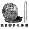 A round metal watch case featuring a dragon design, with seven small dice scattered nearby.