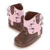 A pair of pink and brown baby Western booties with embroidered floral designs.
