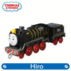 A black and yellow Thomas & Friends diecast train character toy with a white face and red wheels.