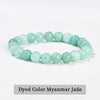 A bracelet made of dyed color Myanmar jade beads on a white background.