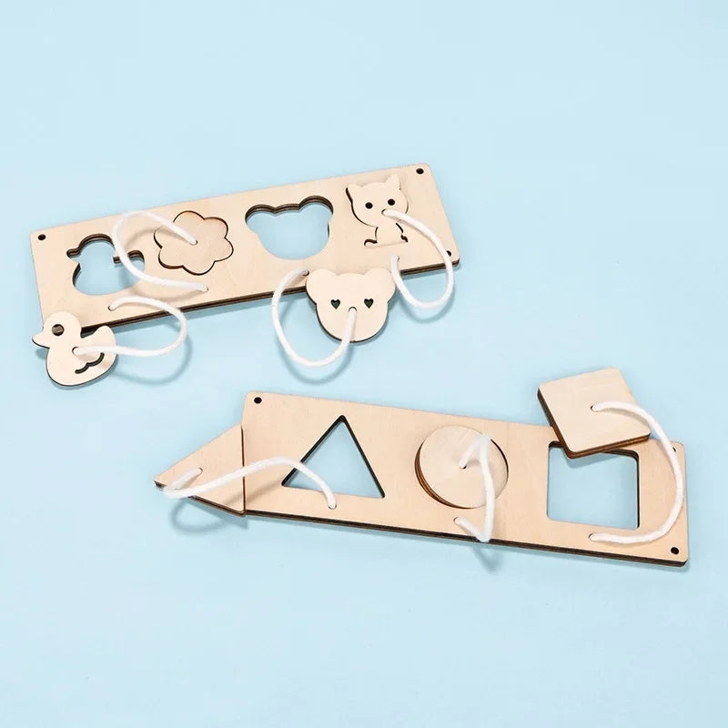A wooden Montessori busy board featuring cutout shapes like a cat, bear, and triangle for sensory play.