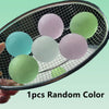 A close-up view of several round, pastel-colored squishy stress cubes resting in a black mesh basket.