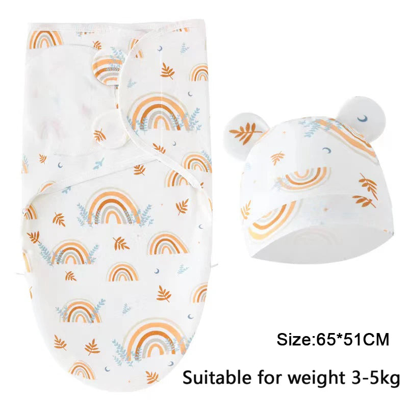 White cotton newborn swaddle blanket and hat set with rainbow and leaf patterns