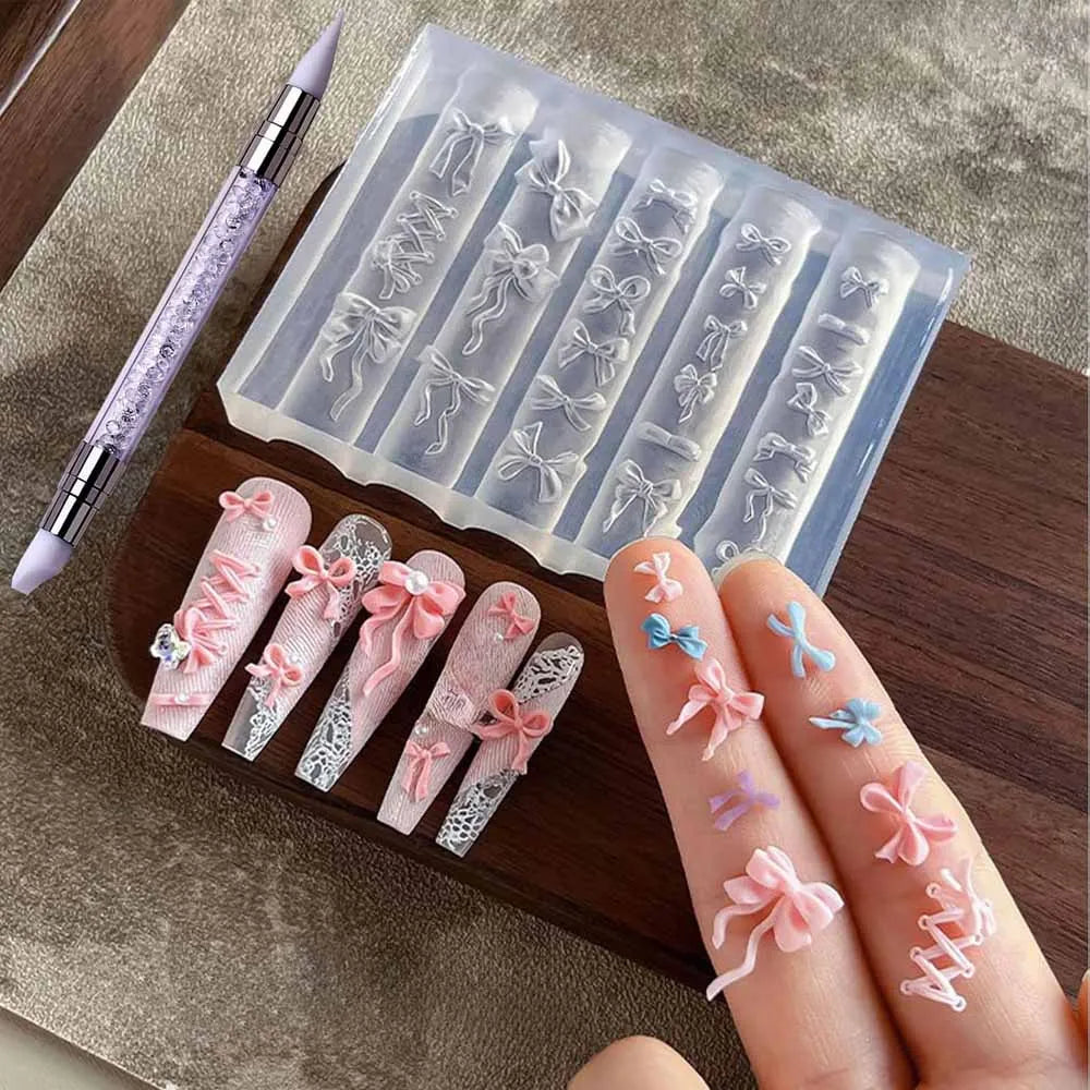 A hand holds silicone nail molds featuring various bowknot designs and a carving pen on a wooden board.
