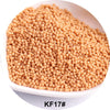 A pile of light beige spherical glass seed beads for jewelry and craft.