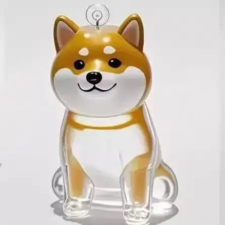 A clear, dog-shaped pet hair keepsake keychain with orange and white markings.
