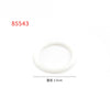 A white, circular rubber band building block is shown.