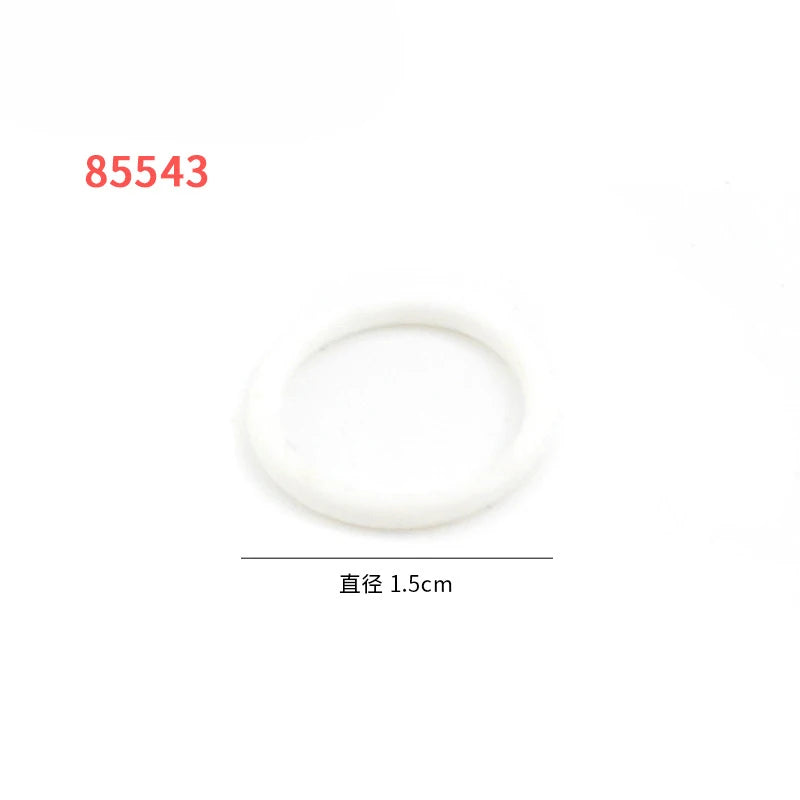A white, circular rubber band building block is shown.