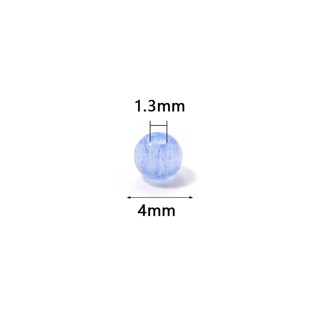 A round, light blue glass bead measuring 1.3mm in height and 4mm in diameter.