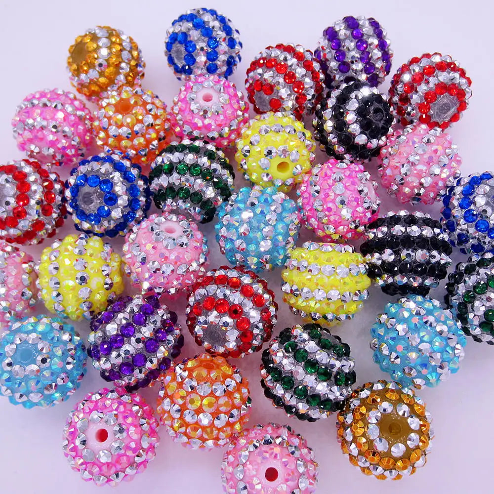 A collection of mixed two-tone striped resin beads in various colors and patterns for jewelry making