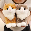 A pair of fluffy orange and gray kitten plush toys being held by a person.