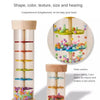 A wooden cylinder toy with colored plastic balls inside, designed to make a rain sound for early learning.