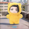 A yellow plush toy resembling a cat with a hood and black hair, displayed outdoors.