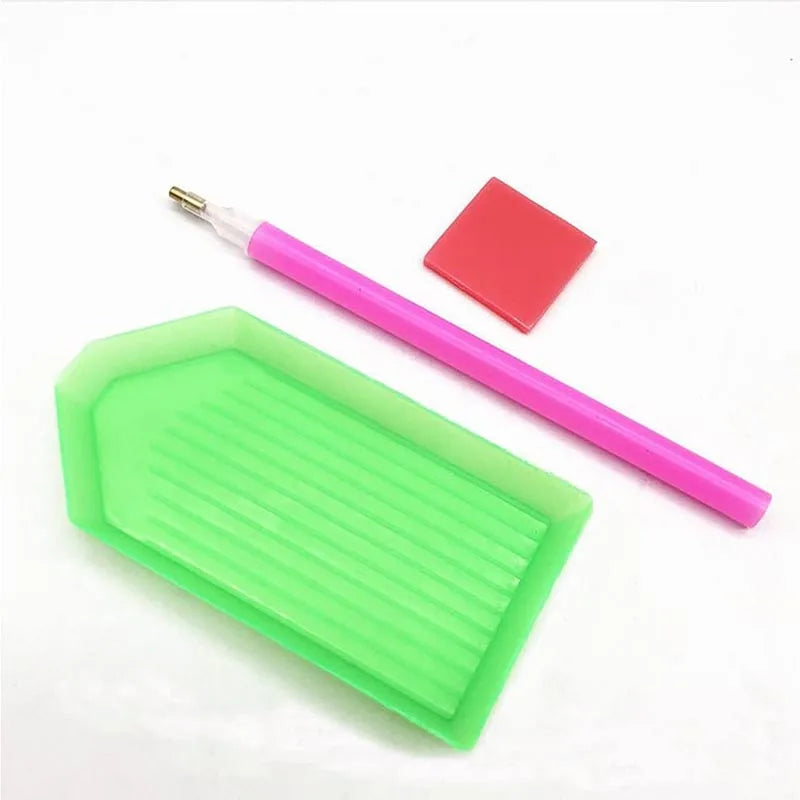A pink ergonomic drill pen and a red square tool for diamond painting