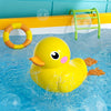 A yellow rubber duck floating in blue water with a green plastic ring and a yellow and orange ring nearby.