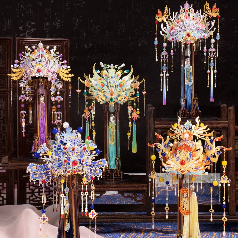 A collection of ornate 3D metal phoenix crown models and puzzle decorations displayed on a dark background.