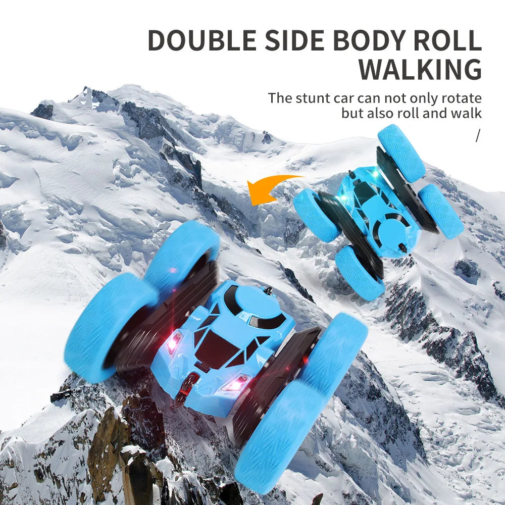 A blue and black double-side body roll walking stunt RC car navigating a snowy mountain landscape.