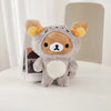 A soft gray Rilakkuma anime plush bear with orange ears and a white chest sitting on a white surface.