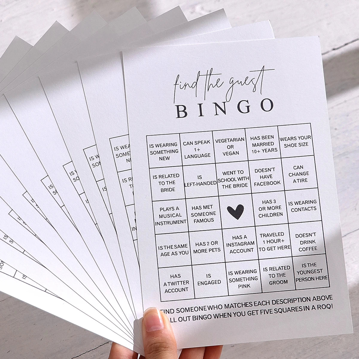 A bingo card for a bridal shower game titled Find the Guest Bingo featuring various characteristics like wearing a new dress 