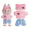 A set of pink and blue knitted outfits for a doll figure including a sweater and shorts.