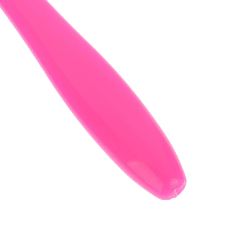 A bright pink orthodontic interdental brush with soft bristles shown in a close-up view.