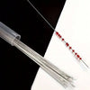 A set of ten ultra-fine metal beading needles for jewelry making laid out on a white surface.
