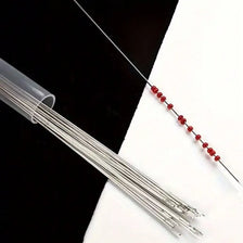 A set of ten ultra-fine metal beading needles for jewelry making laid out on a white surface.