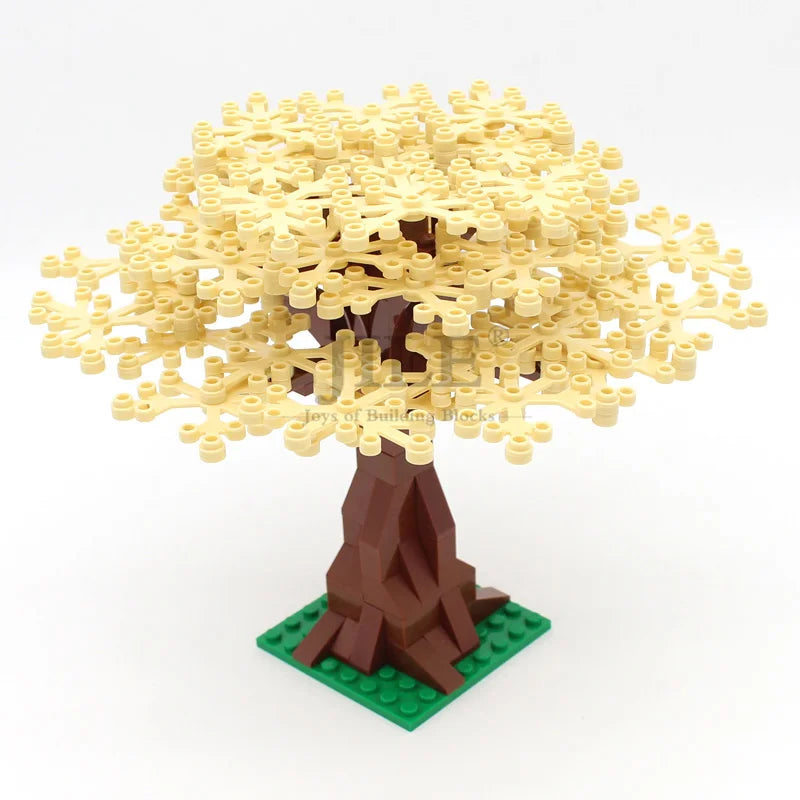 A model of a cherry blossom tree built from yellow LEGO-style bricks with a brown trunk and green base.