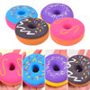 A collection of colorful plastic donut squeeze toys in various colors and sprinkles for sensory play.