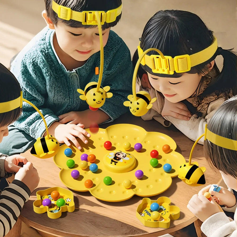 Children playing with a yellow bumblebee board game and fishing toy set on a wooden table.