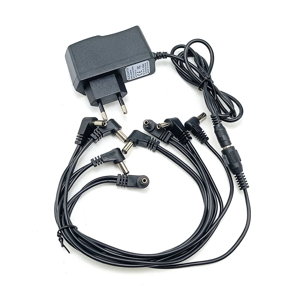 Black power supply adapter for a guitar pedal, featuring multiple output jacks and a main plug.