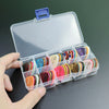 A clear plastic storage box filled with various colored guitar picks and a lid.