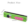 A green wooden harmonica with a cartoon animal design showing musical notes on the body.