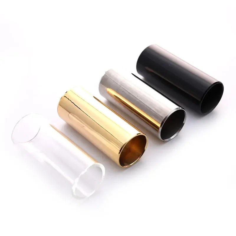 A set of precision guitar slide bars shown in stainless steel and glass, with a black bar also visible.