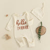 A cream ribbed long sleeve romper and matching hat for a baby boy