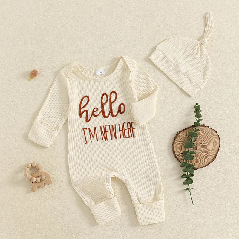 A cream ribbed long sleeve romper and matching hat for a baby boy