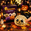 A golden pumpkin-shaped squishy stress ball toy surrounded by autumn leaves and Halloween decorations.