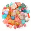 A pile of colorful acrylic beads in various shades including pink, orange, green, blue, and clear.