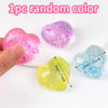 Four iridescent heart-shaped squishy toys in various colors including pink purple yellow and blue