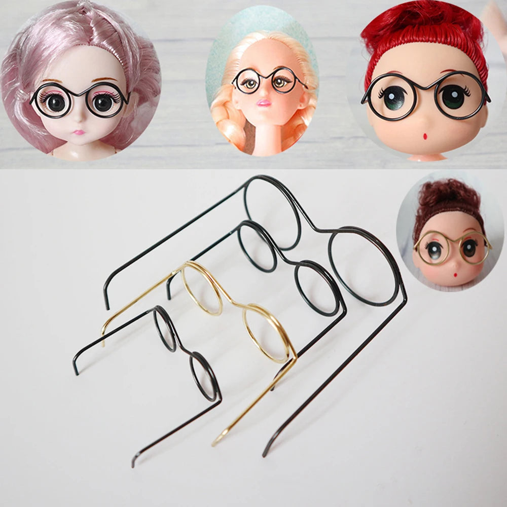 A set of five metal round glasses frames for dolls, featuring various colors and styles.