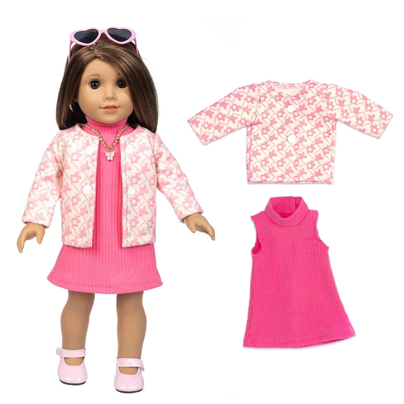 A doll wearing a pink floral coat and matching pink dress, along with a separate pink knit top.