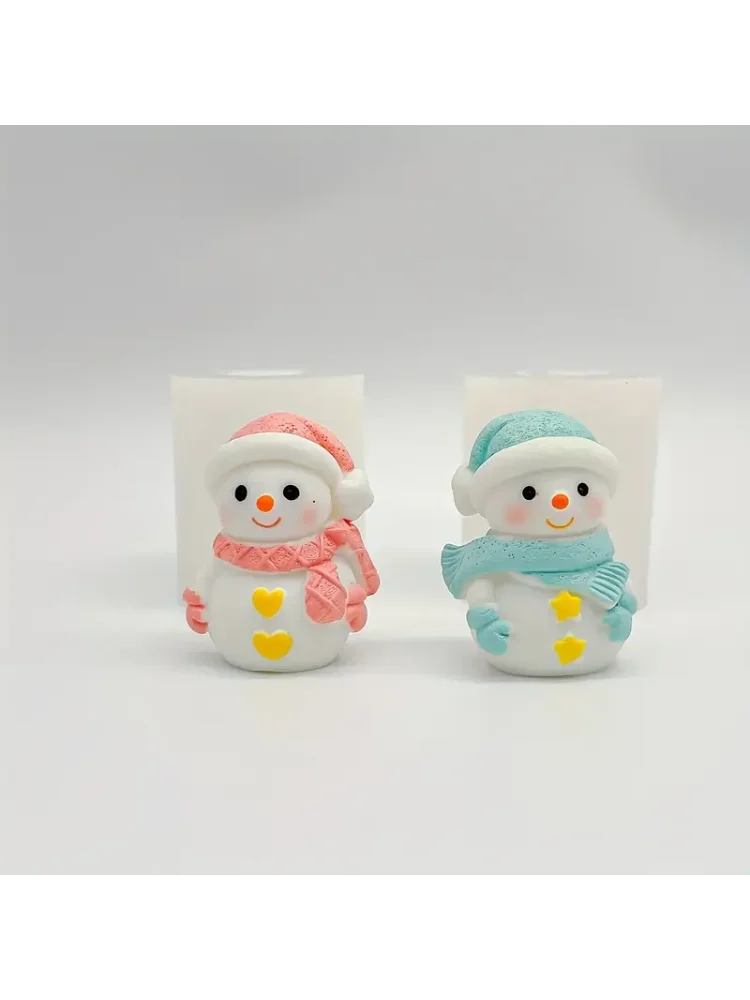 Two silicone molds of smiling snowmen, one pink and one blue, used for crafting candles and resin.