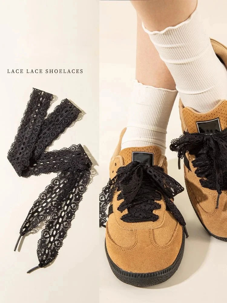 A close-up of brown suede shoes tied with black lace shoelaces on a person's foot.