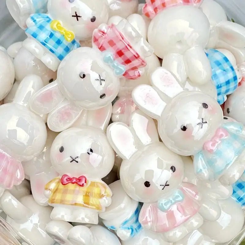 A collection of white and pink Miffy 3D resin bead phone charm keychains in various shapes and expressions.
